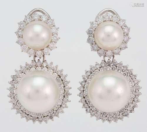 A pair of diamond and cultured pearl earrings, each supporti...