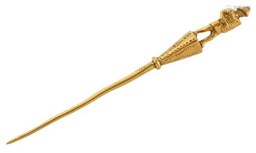 A 19th century gold stickpin, terminating in the figure of a...