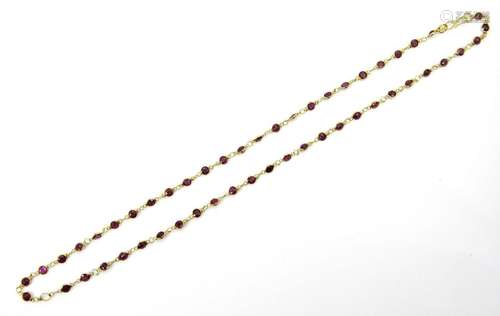 A ruby necklace, composed of a line of circular-cut rubies i...