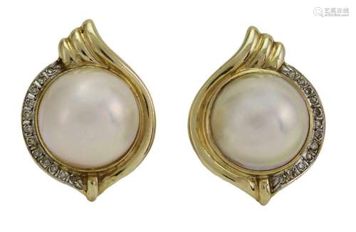 A pair of cultured mabe pearl and diamond earclips, each cen...