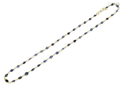 A sapphire necklace, composed of a line of pear and oval-cut...