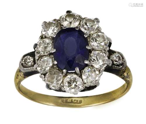 A sapphire and diamond cluster ring, the single oval-cut sap...