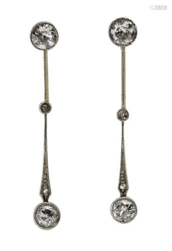 A pair of diamond drop earrings, each composed of three circ...