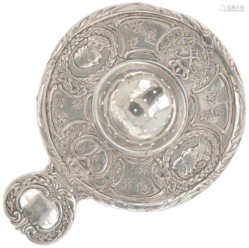 Silver tea strainer.