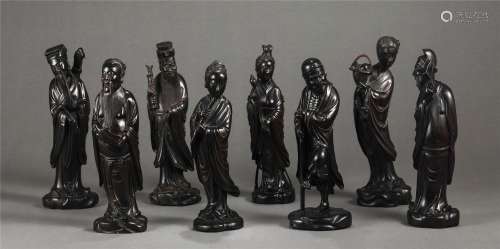 A Group of Eight Carved Rosewood Standing Immortals