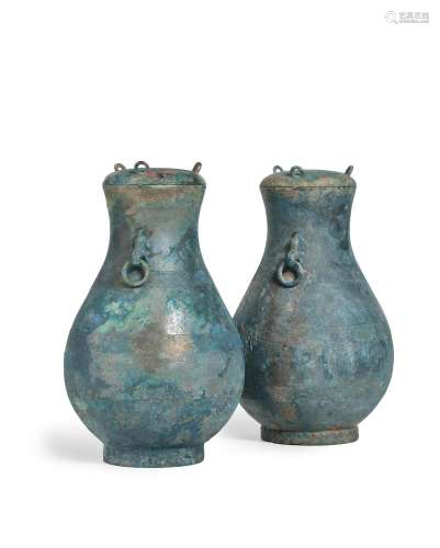 A pair of archaic bronze ritual wine vessels and covers, hu