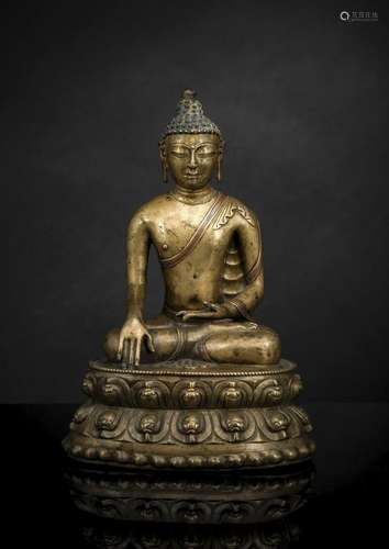 A FINE AND EARLY BRONZE FIGURE OF GAUTAMA BUDDHA WITH COPPER...