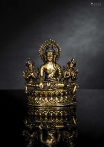 A RARE BRONZE TRIAD DEPICTING BUDDHA SHAKYAMUNI AND A PAIR O...