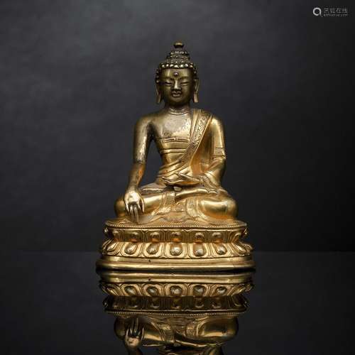 A PARCEL GILT-BRONZE FIGURE OF BUDDHA SHAKYAMUNI