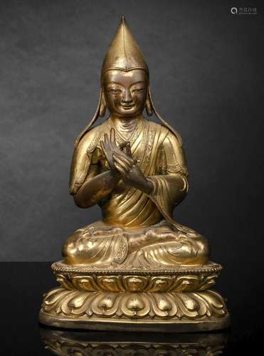 A GILT-COPPER REPOUSSÉ FIGURE OF A LAMA, A KAPALA AND STAND ...