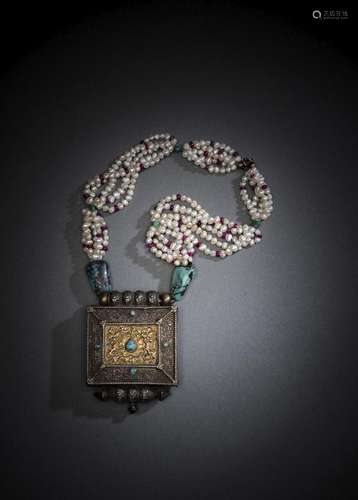 A SILVER AND BRASS AMULET BOX WITH A PEARL AND STONE NECKLAC...