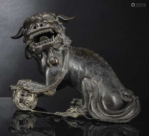 A BRONZE CENSER OF A LION WITH BALL