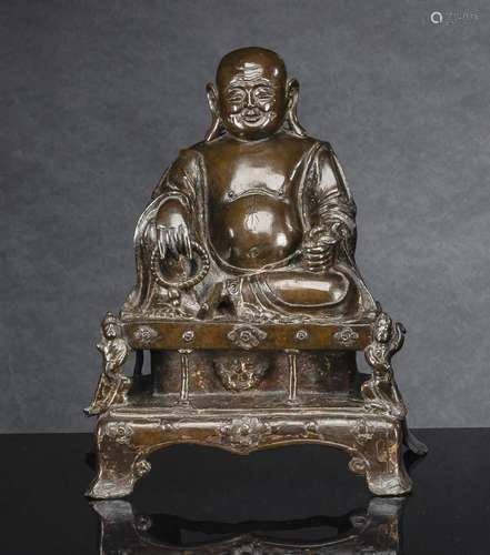 A BRONZE FIGURE OF BUDAI SEATED ON A THRONE