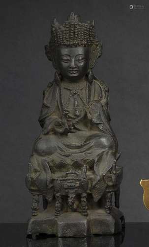 A BRONZE FIGURE OF GUANYIN SEATED ON A THRONE