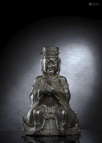 A BRONZE FIGURE OF SEATED SHUIGUAN ON A PEDESTAL