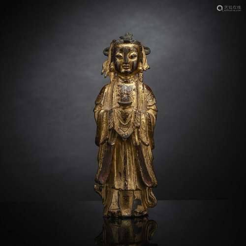 A GILT-LACQUERED BRONZE FIGURE OF A FEMALE ADORANT WITH OFFE...