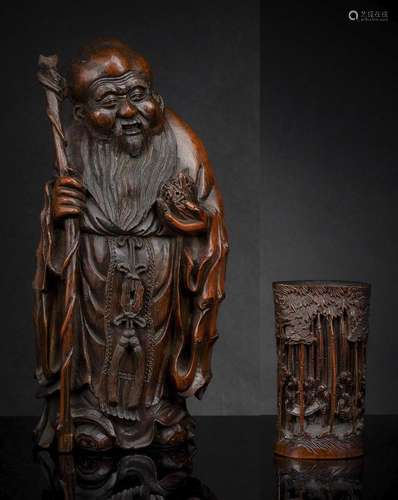 A CARVED BAMBOO FIGURE OF STANDING SHOULAO AND A BAMBOO BRUS...