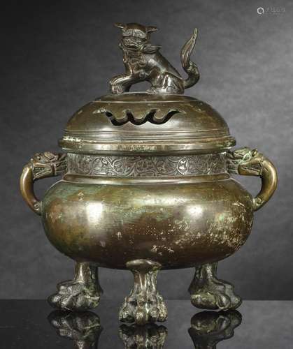 A BRONZE CENSER AND COVER ON THREE FEET WITH LION HANDLE