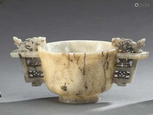 A FINE CARVED GREEN-GREY JADE WINECUP WITH DRAGON HANDLES