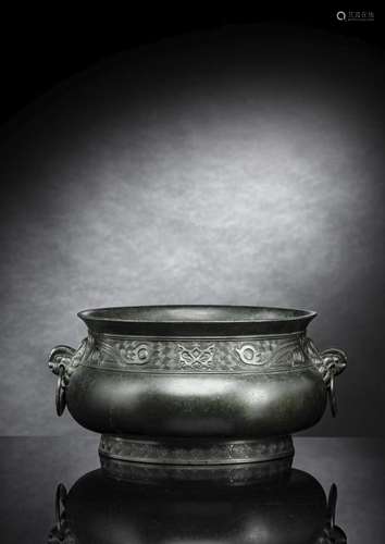 A BRONZE CENSER IN ARCHAIC STYLE WITH MASK HANDLES