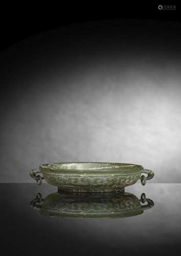 A FINE CARVED LIGHT GREEN JADE BOWL WITH TWO HANDLES IN ARCH...