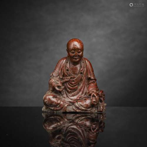 A VERY FINE CARVED RED AND GREY SOAPSTONE SEATED LUOHAN