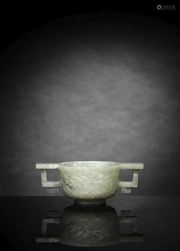 A FINE CARVED WHITE JADE LOTUS CUP WITH TWO HANDLES