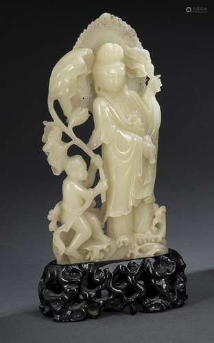 A FINE CARVED SOAPSTONE MODEL OF GUANYIN AND BOY ON A CARVED...