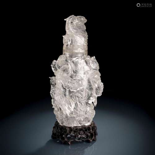 A LARGE CARVED BIRD AND FLOWER ROCK CRYSTAL VASE AND COVER