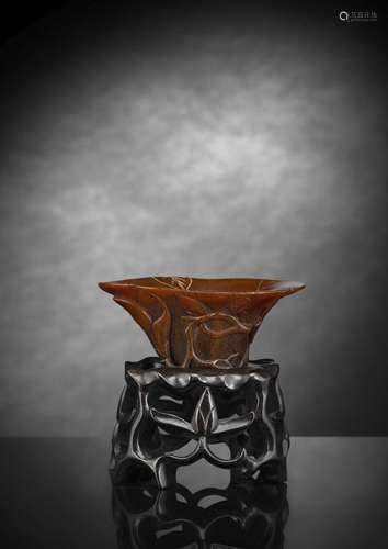 A WELL CARVED BROWN MAGNOLIA RHINOHORN WINE CUP WITH CARVED ...