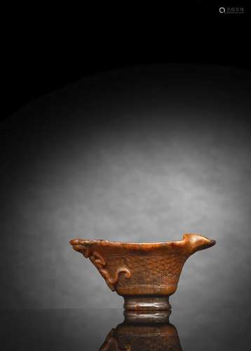 A LIGHT BROWN COLORED RHINOHORN LIBATION CUP WITH CHILONG HA...