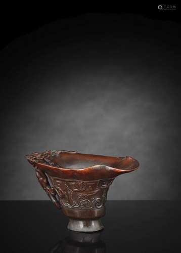 A FINE CARVED BROWN RHINORN WINE CUP WITH TAOTIE MASKS AND C...