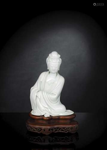 A FINE DEHUA MODEL OF SEATED GUANYIN AND WOOD STAND