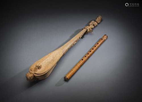 A FLUTE AND WOOD LUTE WITH A CARVED HEAD