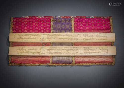 A BUDDHIST MANUSCRIPT WITH CLOTH WRAPPING