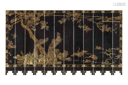 A TWELVE-PIECE COROMANDEL FOLDING SCREEN DECORATED WITH TWO ...