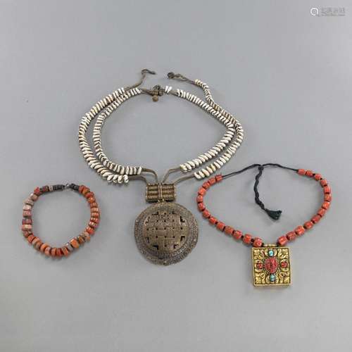 TWO AMULETS WITH SHELLS AND CORAL CHAINS AND AN AGATE PRAYER...