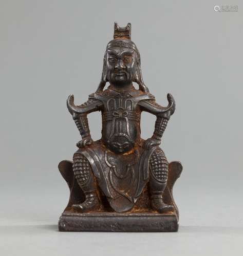 A CAST-IRON FIGURE OF A SEATED GUARDIAN