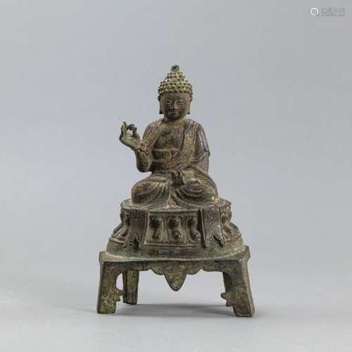 A BRONZE FIGURE OF BUDDHA ON A FOUR-FOOTED STAND