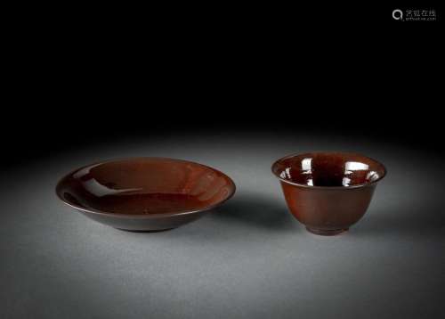 A GERMAN EARTHENWARE BROWN-GROUND TEABOWL AND SAUCER