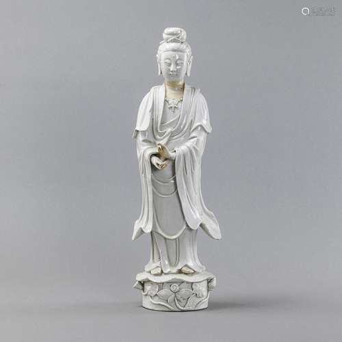 A 'DEHUA' FIGURE OF GUANYIN STANDING ON A LOTUS BA...