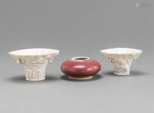 TWO DEHUA PORCELAIN CUPS WITH RELIEF DECORATION AND A BRUSH ...