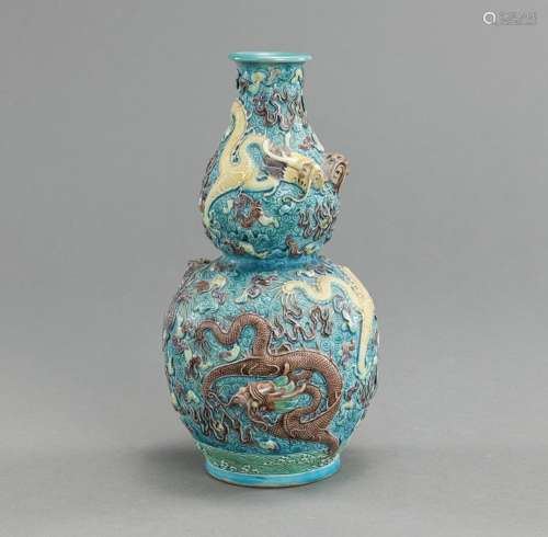 A FINE FAHUA-STYLE MOLDED BISCUIT PORCELAIN VASE WITH DRAGON...