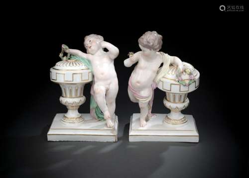 A PAIR OF HÖCHST GROUPS OF PUTTI WITH URNS
