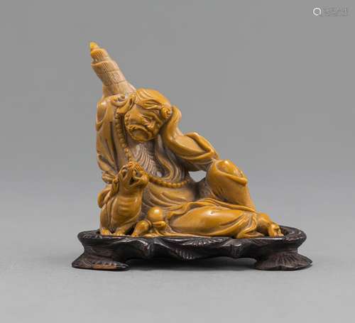 RESTING LUOHAN WITH A DOG CARVED FROM YELLOWISH SOAPSTONE ON...