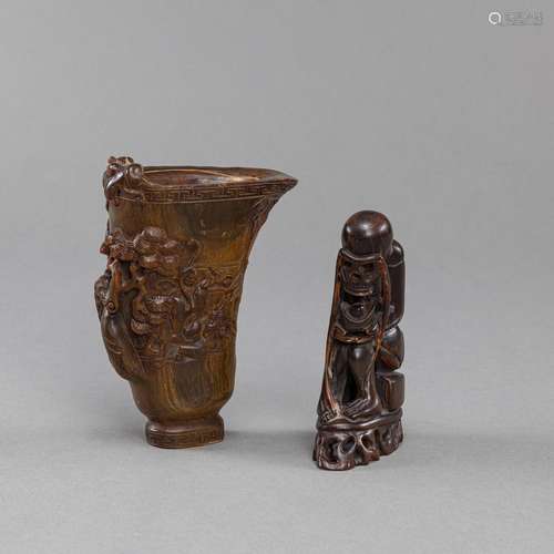 TWO HORN CARVINGS OF A LIBATION CUP AND A SKELETON