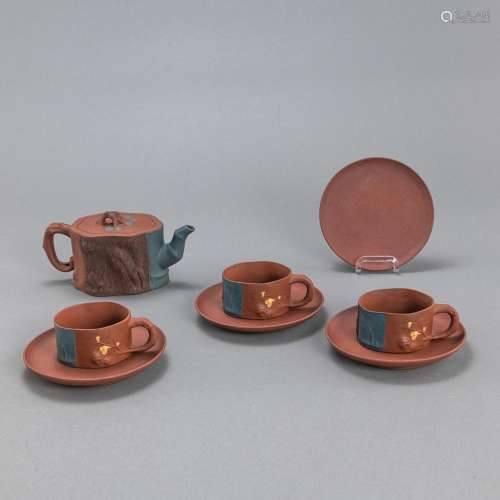 AN 'YIXING' TEA SET WITH A POT, THREE CUPS, AND FO...