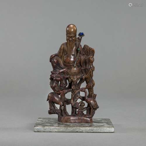 A FINE CARVED SOAPSTONE MODEL OF SHOULAO AND DEER SEATED ON ...