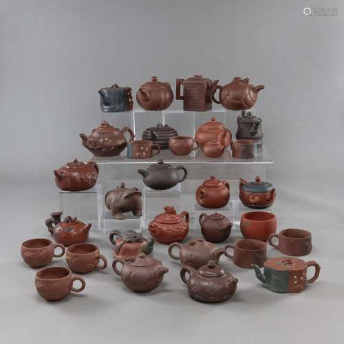 A GROUP OF ZISHA TEAPOTS AND COVERS AND CUPS