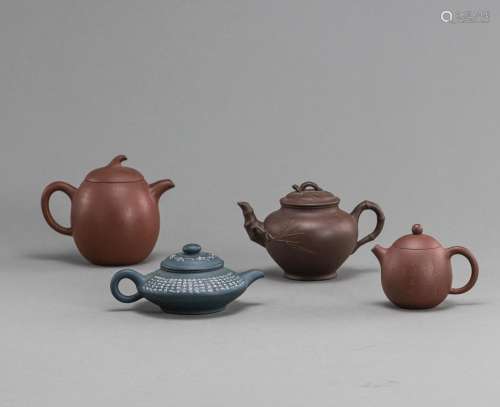 A GROUP OF FOUR ZISHA TEAPOTS AND COVERS PARTLY ENGRAVED